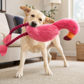 Labrador carrying the Chewvox extra large flamingo plush tug toy by its rope leg